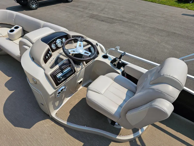 Slide: The Image of 2014 Bennington 2275 GL boat interior with steering wheel and seating. - 9