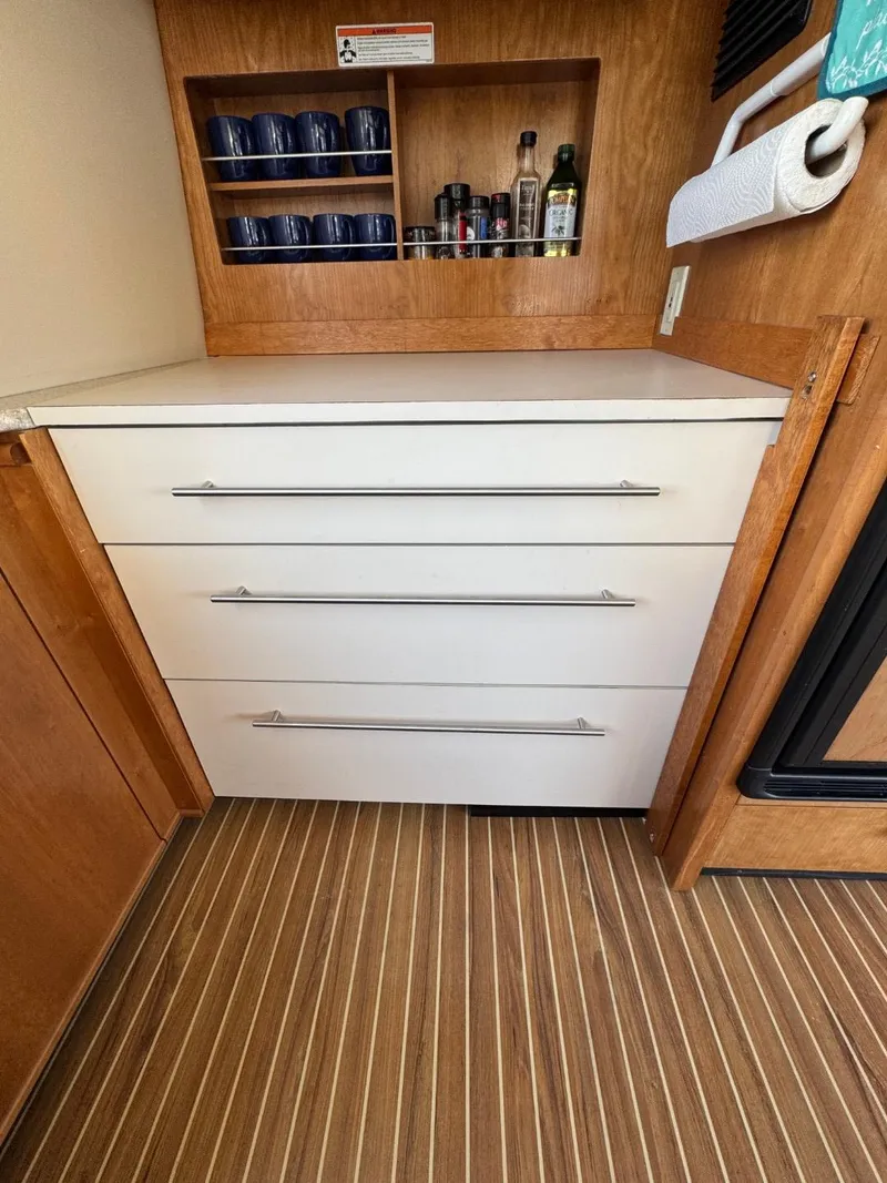 Slide: The Image of Interior of 2003 Meridian 490 Pilothouse Yacht with drawers and shelves. - 13