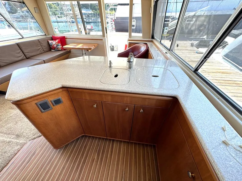 Slide: The Image of Luxurious 2003 Meridian 490 Pilothouse Motor Yacht interior with modern kitchen and seating area. - 16