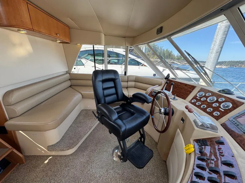 Slide: The Image of 2003 Meridian 490 Pilothouse Motor Yacht interior with helm, seating, and control panel. - 17