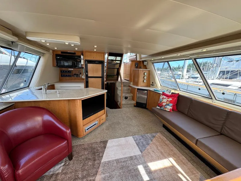 Slide: The Image of Luxurious interior of 2003 Meridian 490 Pilothouse Motor Yacht with modern furnishings and large windows. - 2