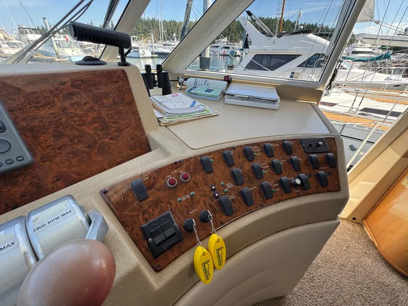 Slide: The Image of Control panel of a 2003 Meridian 490 Pilothouse Motor Yacht in a marina setting. - 25