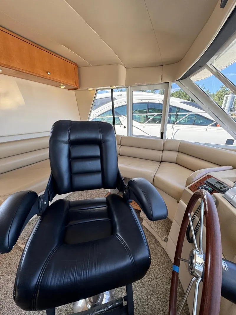 Slide: The Image of 2003 Meridian 490 Pilothouse Motor Yacht interior with leather captain's chair and steering wheel. - 26