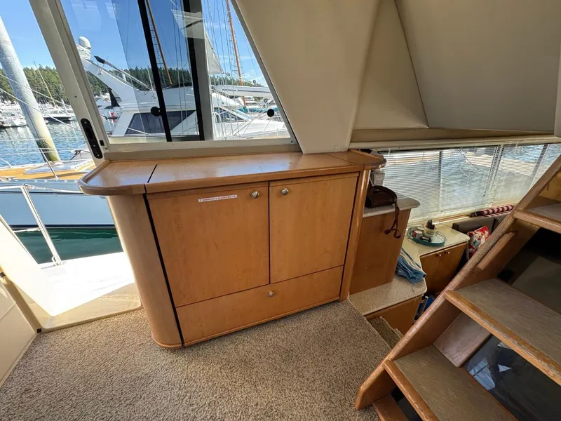 Slide: The Image of 2003 Meridian 490 Pilothouse Motor Yacht interior with wooden cabinetry and carpeted flooring. - 27
