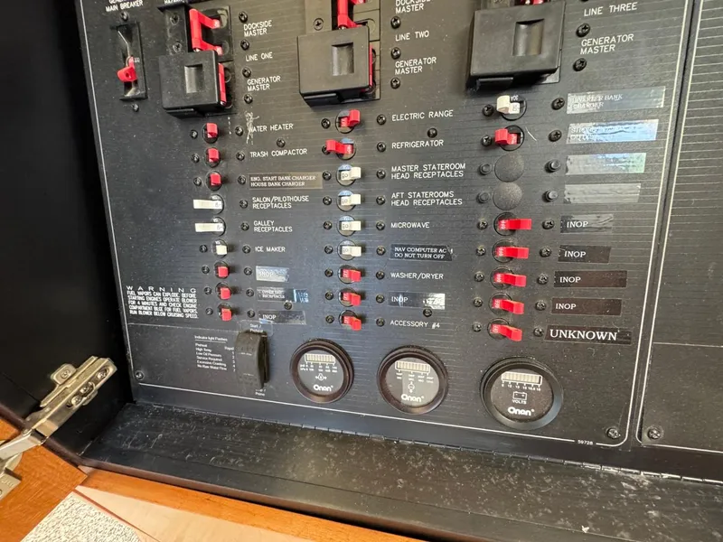 Slide: The Image of Electrical panel of a 2003 Meridian 490 Pilothouse Motor Yacht with labeled switches and gauges. - 30