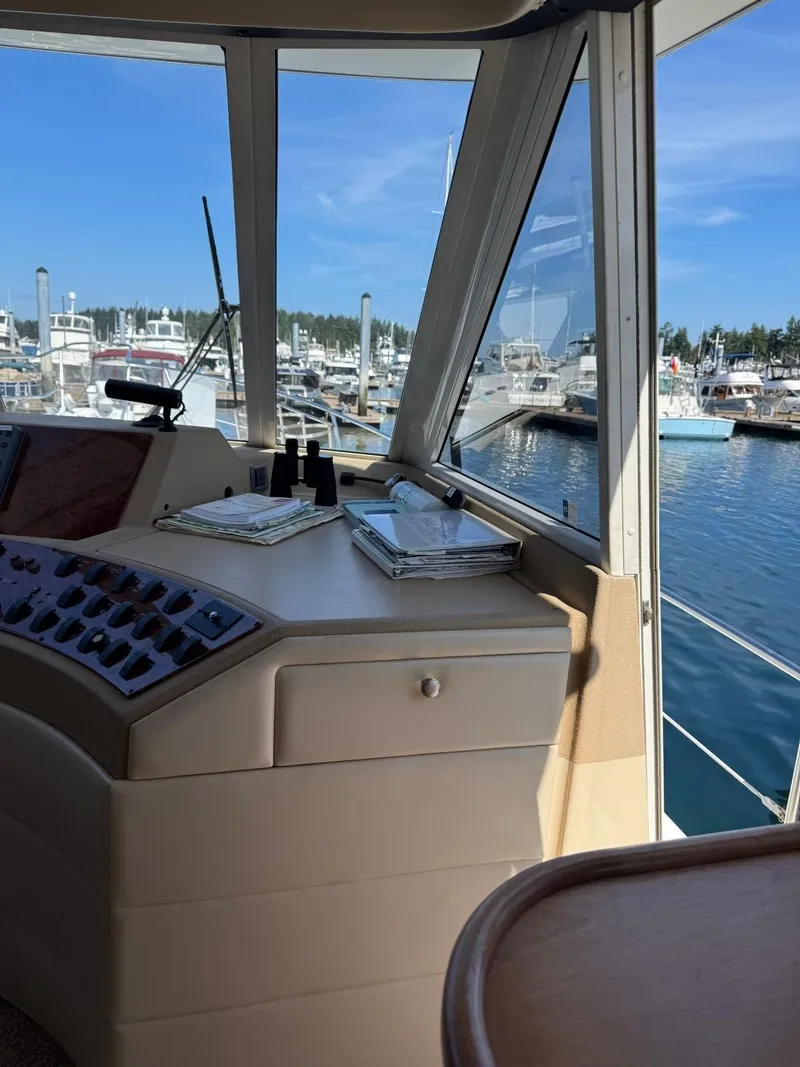 Slide: The Image of Pilothouse interior of 2003 Meridian 490 Motor Yacht, overlooking marina with clear blue sky. - 31