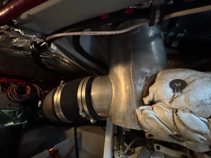 Slide: The Image of Engine room of 2003 Meridian 490 Pilothouse Motor Yacht showing exhaust system components. - 36