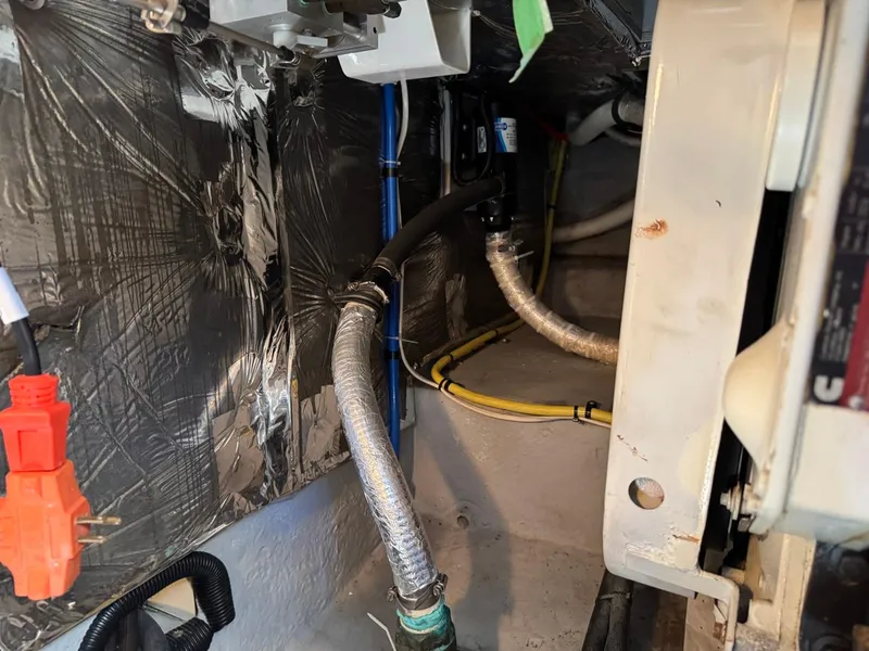 Slide: The Image of Engine room of 2003 Meridian 490 Pilothouse Motor Yacht, showing wiring and insulated pipes. - 37