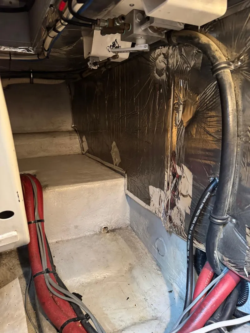 Slide: The Image of Engine room of 2003 Meridian 490 Pilothouse Motor Yacht with cables and insulation. - 38