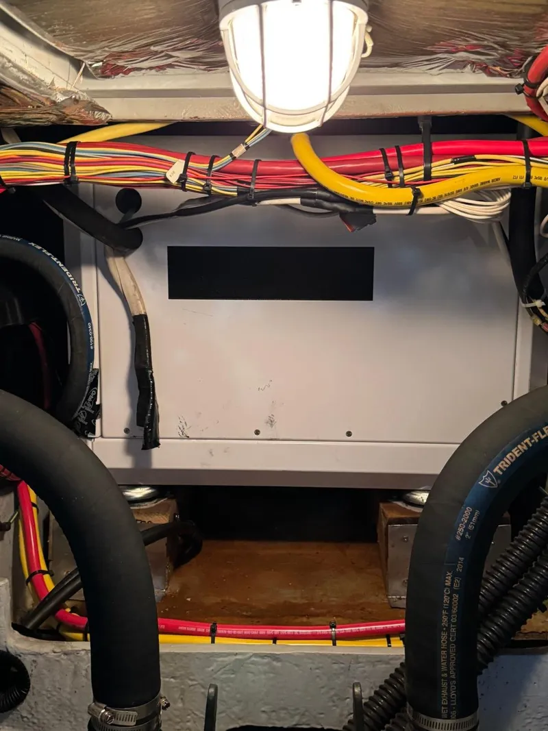 Slide: The Image of Engine room of 2003 Meridian 490 Pilothouse Motor Yacht with wiring and hoses. - 43