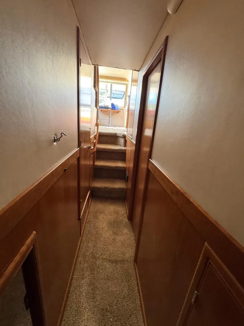 Slide: The Image of Narrow hallway inside 2003 Meridian 490 Pilothouse Motor Yacht with carpeted stairs. - 44
