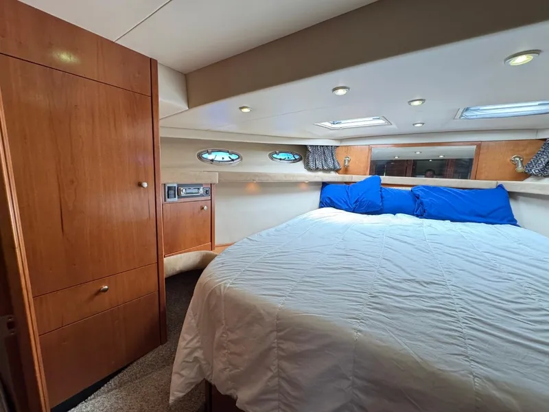 Slide: The Image of Luxurious bedroom in 2003 Meridian 490 Pilothouse Motor Yacht with cozy bedding and wood cabinetry. - 48