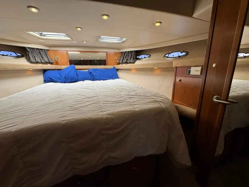 Slide: The Image of Luxurious bedroom in 2003 Meridian 490 Pilothouse Motor Yacht with skylights and wood accents. - 49