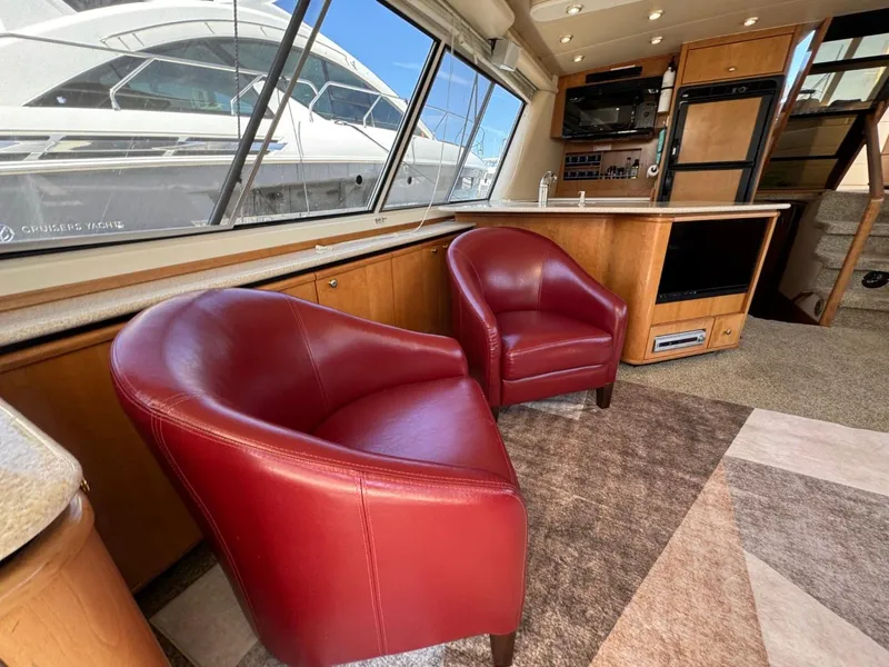Slide: The Image of Luxurious interior of 2003 Meridian 490 Pilothouse Motor Yacht with red leather chairs. - 6
