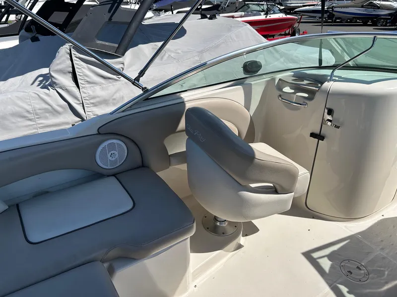 Slide: The Image of 2004 Sea Ray 220 Sundeck interior with seating and speaker, showcasing luxury boat design. - 13