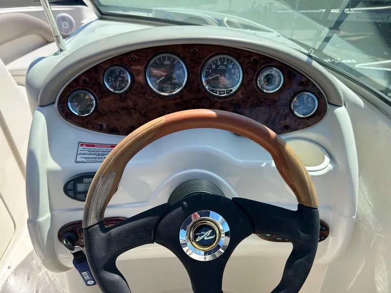 Slide: The Image of Steering wheel and dashboard of 2004 Sea Ray 220 Sundeck boat. - 5