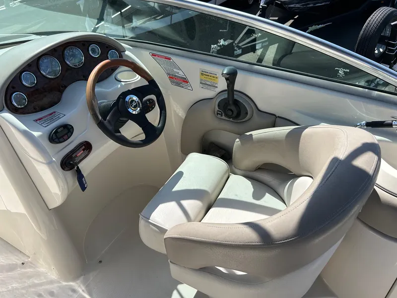 Slide: The Image of 2004 Sea Ray 220 Sundeck cockpit with steering wheel and control panel. - 6