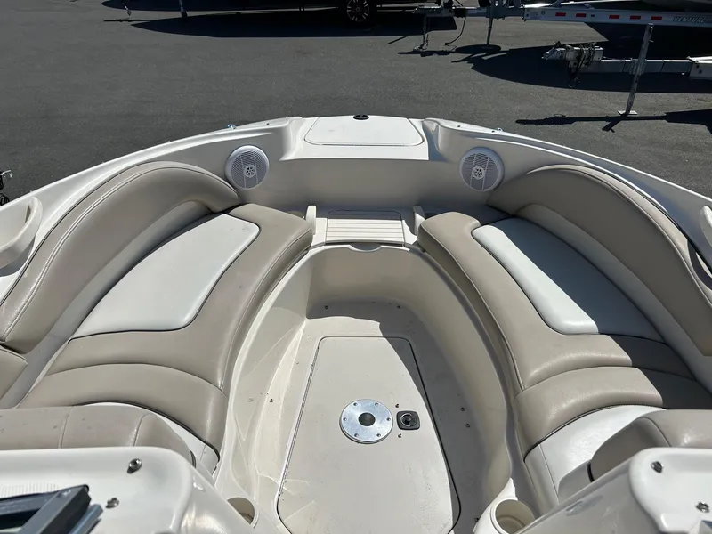 Slide: The Image of 2004 Sea Ray 220 Sundeck interior with beige seating and speakers. - 7
