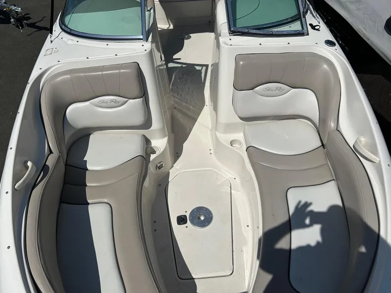 Slide: The Image of 2004 Sea Ray 220 Sundeck interior with beige seating and open deck layout. - 8