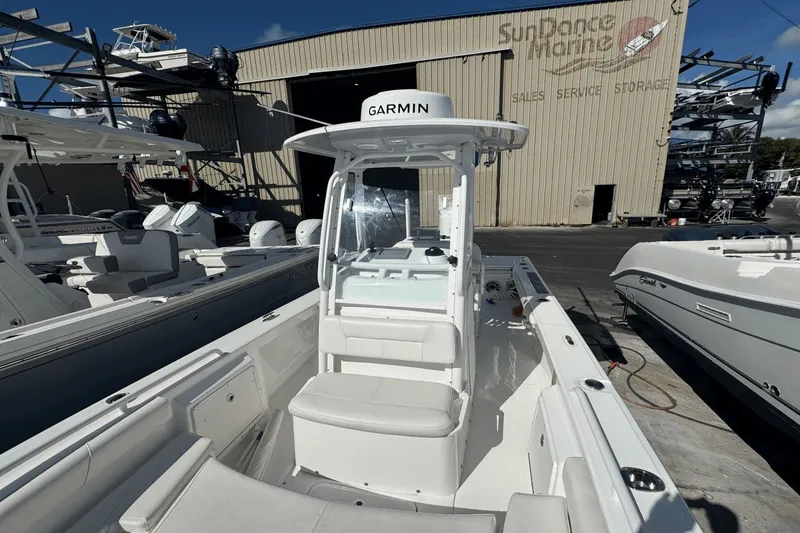 Slide: The Image of 2021 Everglades 243 CC boat at marina, featuring Garmin equipment, Sundance Marine building in background. - 10