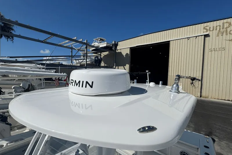 Slide: The Image of 2021 Everglades 243 CC boat with Garmin equipment, parked outside a sales warehouse. - 14