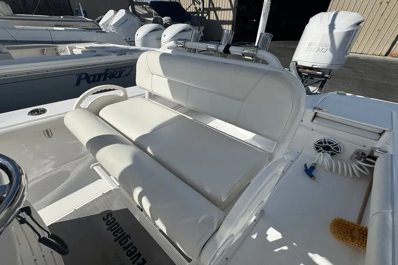 Slide: The Image of 2021 Everglades 243 CC boat interior with white seating and Yamaha 300 engine. - 16