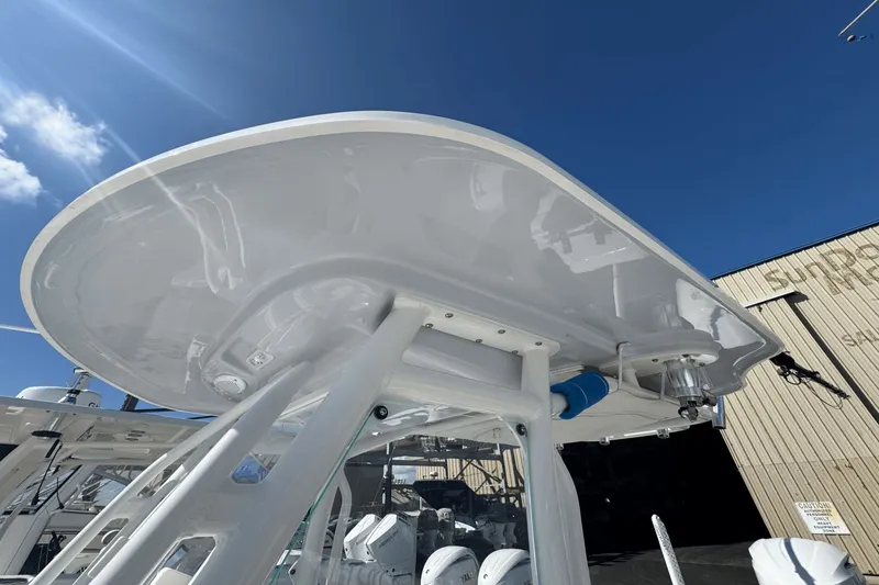 Slide: The Image of 2021 Everglades 243 CC boat with T-top under clear blue sky. - 17