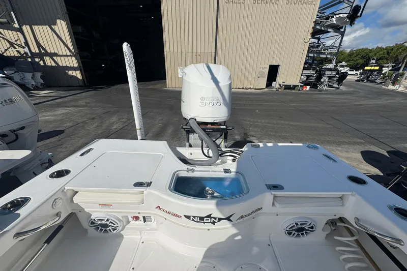 Slide: The Image of 2021 Everglades 243 CC boat with Yamaha 300 engine at a storage facility. - 22