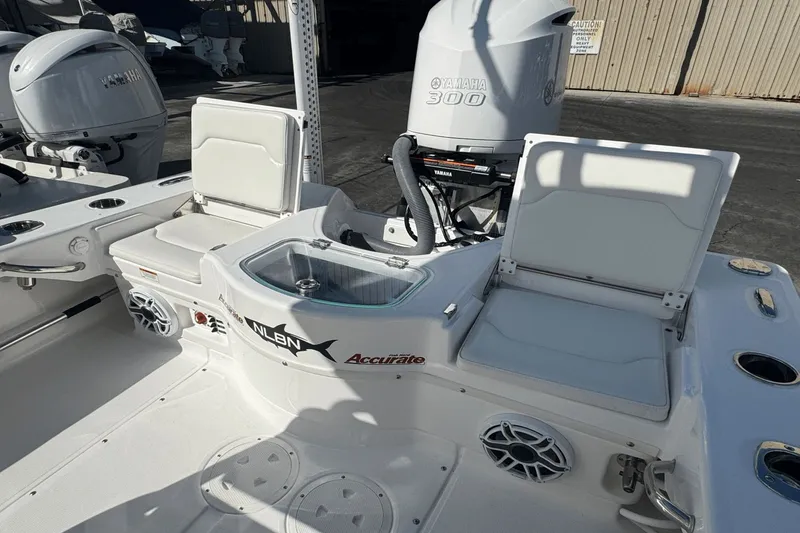 Slide: The Image of 2021 Everglades 243 CC boat interior with Yamaha 300 engine, featuring seating and storage. - 24