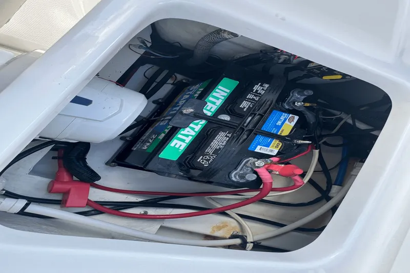 Slide: The Image of Battery compartment of 2021 Everglades 243 CC boat with wiring and connections. - 25