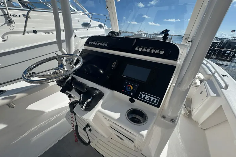 Slide: The Image of 2021 Everglades 243 CC boat console with steering wheel and navigation system. - 27