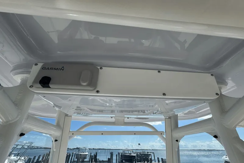Slide: The Image of Garmin device on 2021 Everglades 243 CC boat, with marina view in background. - 31