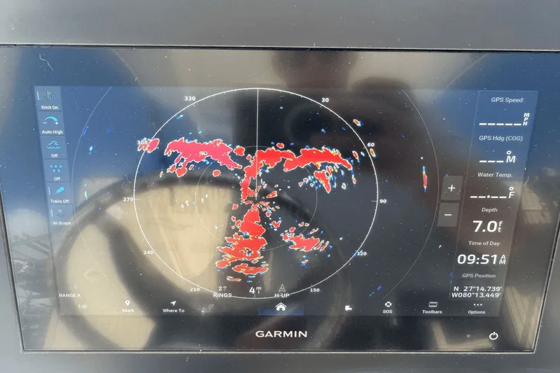 Slide: The Image of Garmin marine radar display on Everglades 243 CC, 2021 model, showing depth and GPS coordinates. - 33