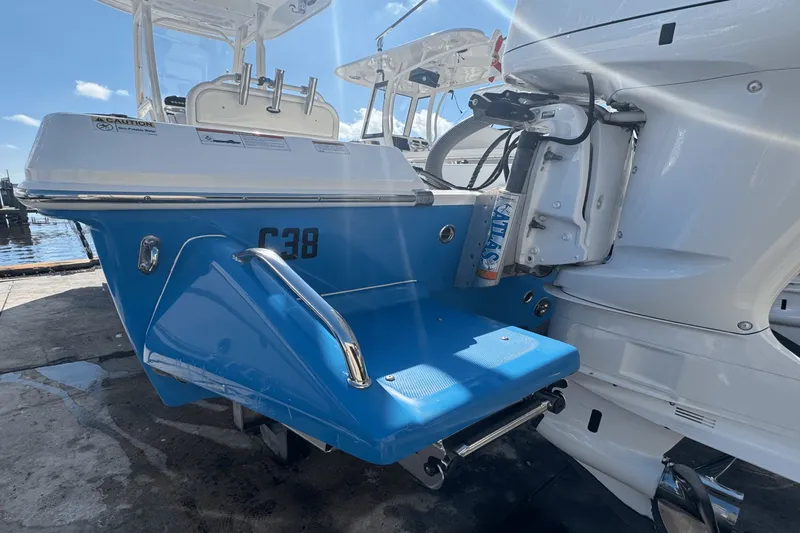 Slide: The Image of 2021 Everglades 243 CC boat with blue swim platform and outboard motor. - 5