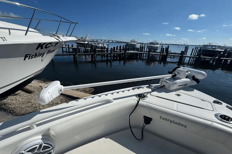 Slide: The Image of Everglades 243 CC boat docked, featuring Minn Kota trolling motor, clear sky, and marina view. - 8