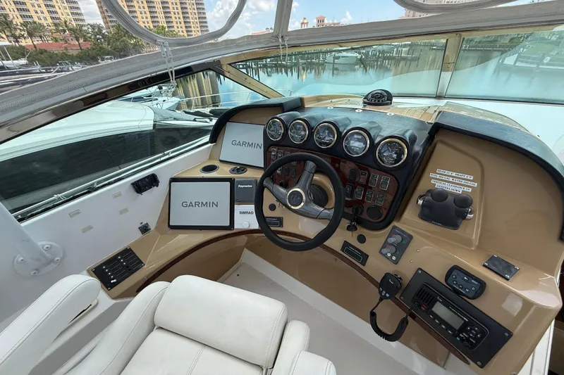 Slide: The Image of Pilothouse of 2002 Carver 570 Voyager with Garmin navigation systems and classic steering wheel. - 10