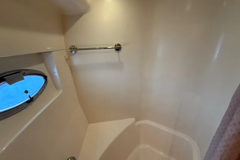 Slide: The Image of Shower area in 2002 Carver 570 Voyager Pilothouse with porthole and towel rack. - 23