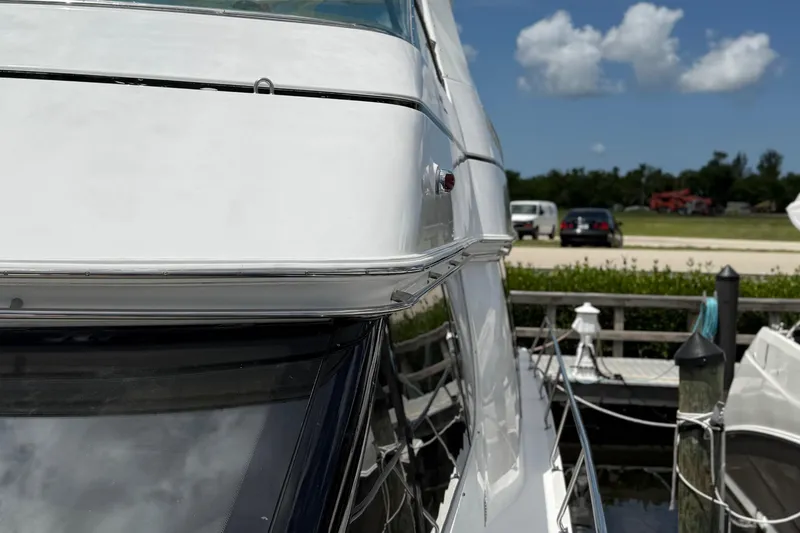 Slide: The Image of 2002 Carver 570 Voyager Pilothouse docked under a clear blue sky. - 4