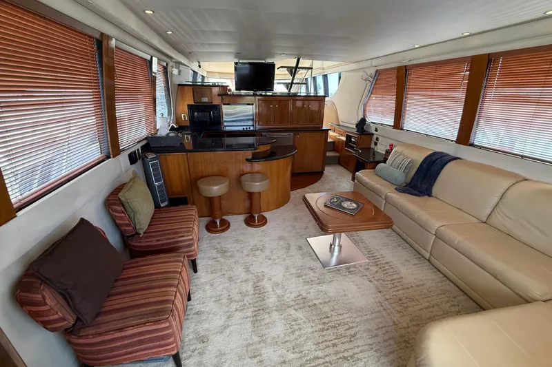 Slide: The Image of Luxurious interior of 2002 Carver 570 Voyager Pilothouse with modern furnishings and wood accents. - 11