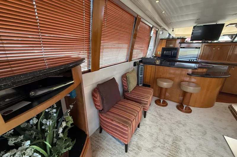 Slide: The Image of Luxurious interior of 2002 Carver 570 Voyager Pilothouse with seating, kitchen, and decor. - 13