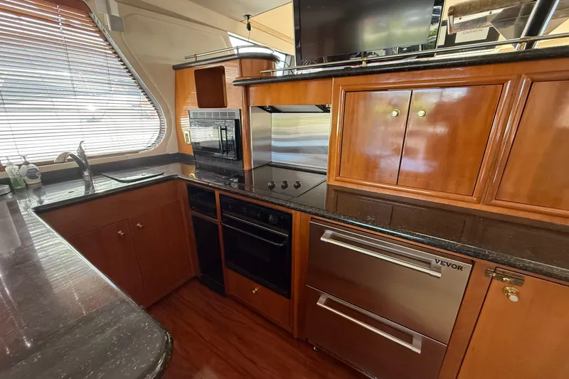 Slide: The Image of Luxurious kitchen interior of 2002 Carver 570 Voyager Pilothouse yacht with modern appliances. - 16
