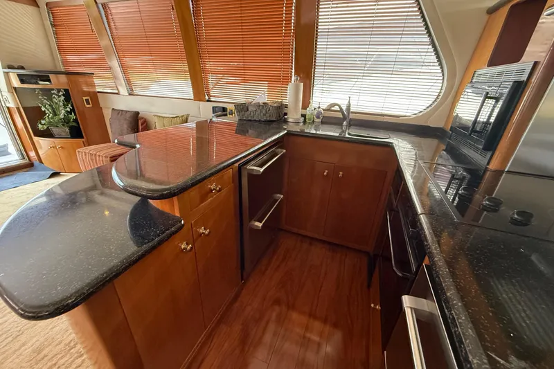 Slide: The Image of Luxurious kitchen interior of 2002 Carver 570 Voyager Pilothouse yacht with wood cabinetry. - 17