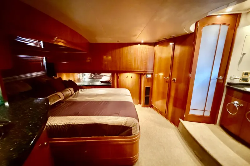 Slide: The Image of Luxurious interior of 2002 Carver 570 Voyager Pilothouse with elegant wood finishes and cozy bedding. - 20