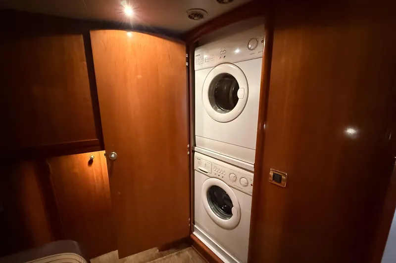 Slide: The Image of Stacked washer and dryer in 2002 Carver 570 Voyager Pilothouse laundry area. - 22