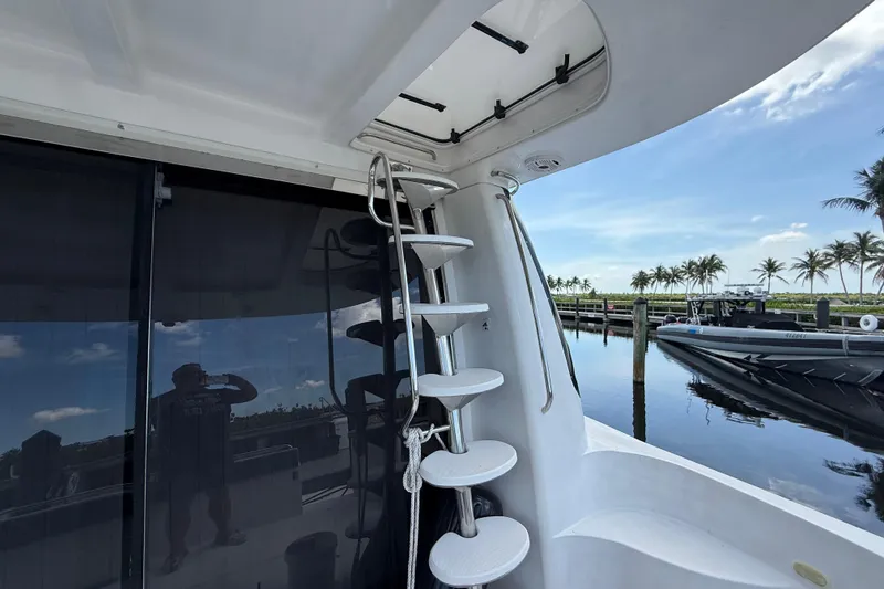 Slide: The Image of 2002 Carver 570 Voyager Pilothouse yacht with spiral staircase and marina view. - 6