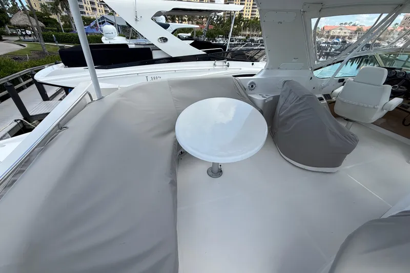 Slide: The Image of 2002 Carver 570 Voyager Pilothouse yacht interior with seating and table on deck. - 7