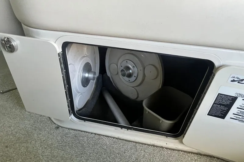 Slide: The Image of Storage compartment in a 2008 Sea Ray 240 Sundeck boat, showing interior details. - 12