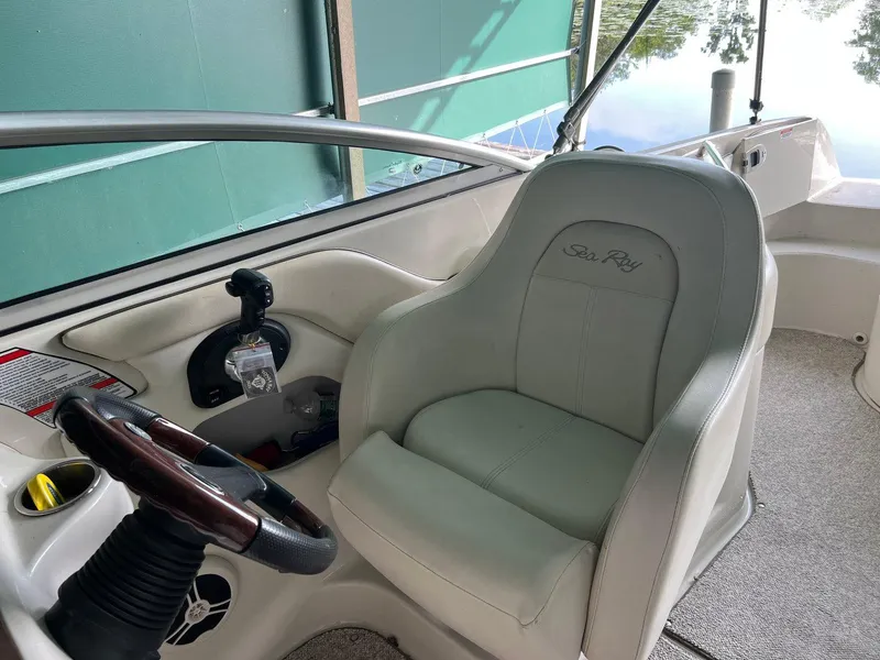 Slide: The Image of 2008 Sea Ray 240 Sundeck interior with steering wheel and captain's chair. - 14