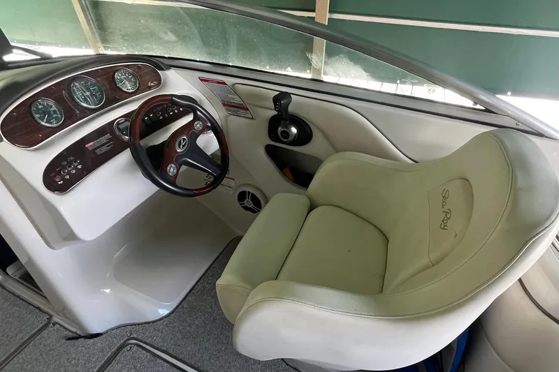 Slide: The Image of 2008 Sea Ray 240 Sundeck cockpit with steering wheel and instrument panel. - 15