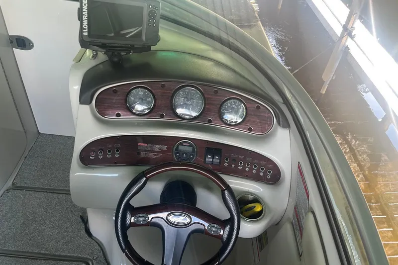 Slide: The Image of 2008 Sea Ray 240 Sundeck dashboard with steering wheel and instrument panel. - 17